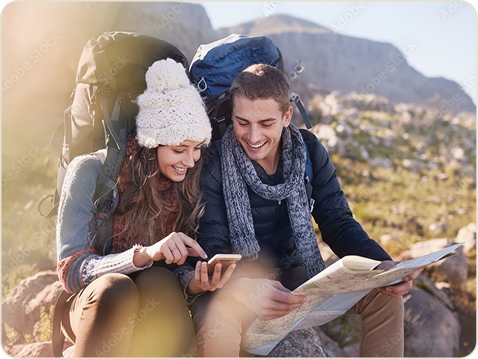 Two hikers checking a map together on the trail